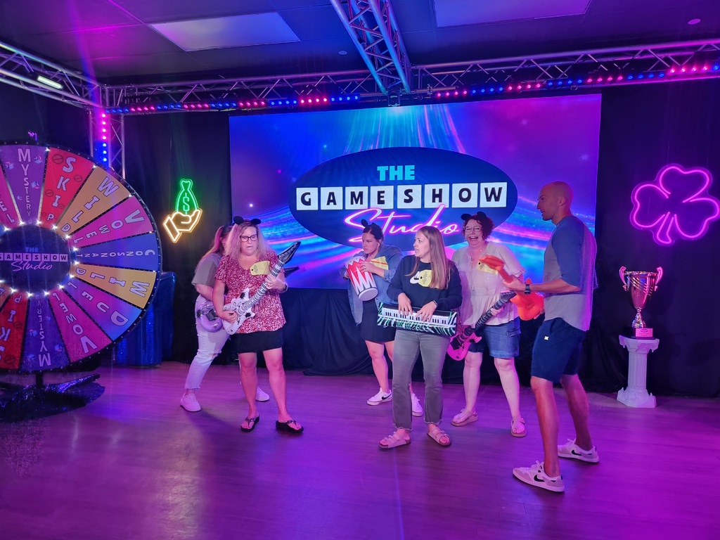 🎬✨ Over the summer, a group of our high school staff enjoyed an evening of fun and team bonding at The Game Show Experience in the Twin Cities!  They got the chance to step into a Hollywood-inspired game show studio and take part in an immersive world of laughter, challenges, and team spirit. 🎤🎉  We love seeing our staff come together outside of school—it makes our Panther team even stronger! 🐾💜  #PantherPride #TeamECSD #GameShowExperience