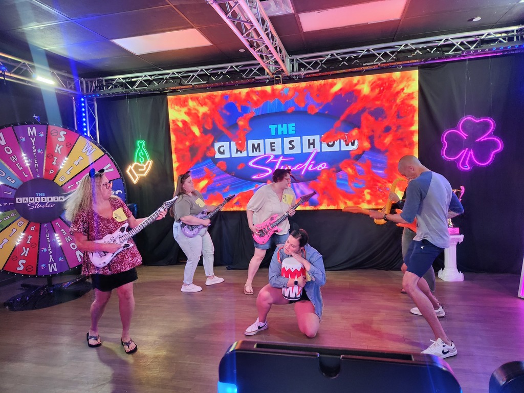 🎬✨ Over the summer, a group of our high school staff enjoyed an evening of fun and team bonding at The Game Show Experience in the Twin Cities!  They got the chance to step into a Hollywood-inspired game show studio and take part in an immersive world of laughter, challenges, and team spirit. 🎤🎉  We love seeing our staff come together outside of school—it makes our Panther team even stronger! 🐾💜  #PantherPride #TeamECSD #GameShowExperience