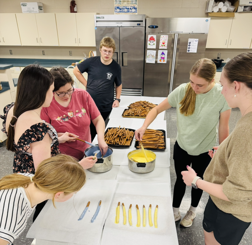On October 19, the Ellsworth Hearts & Minds group completed another successful shipment of school supplies and comfort items to Ukraine, this time to a school in Radomyshl', located in the region of Zhytomyr Oblast in north-central Ukraine, about 70 miles west of Kyiv. After months of dedicated fundraising, the Hearts & Minds students raised enough money to purchase the supplies and cover shipping costs. With help from Day of Service volunteers, supplies were packaged. With the help of Ryan, my dad, Tom Benson, and his wife, Valentyna—who is from Radomyshl—19 boxes were labeled and shipped, each one carrying the compassion, encouragement, and hope of an entire school community reaching across the world.
