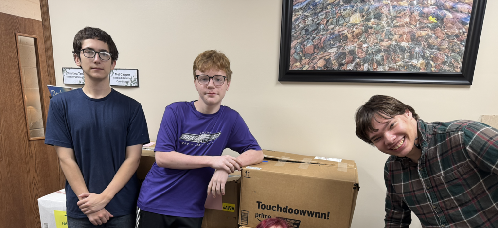 On October 19, the Ellsworth Hearts & Minds group completed another successful shipment of school supplies and comfort items to Ukraine, this time to a school in Radomyshl', located in the region of Zhytomyr Oblast in north-central Ukraine, about 70 miles west of Kyiv. After months of dedicated fundraising, the Hearts & Minds students raised enough money to purchase the supplies and cover shipping costs. With help from Day of Service volunteers, supplies were packaged. With the help of Ryan, my dad, Tom Benson, and his wife, Valentyna—who is from Radomyshl—19 boxes were labeled and shipped, each one carrying the compassion, encouragement, and hope of an entire school community reaching across the world.