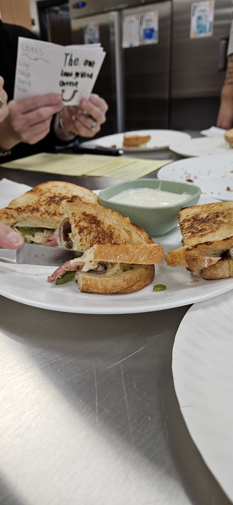 Students in Mrs. Johnson’s Food Service classes took part in the annual Grilled Cheese Challenge last week, and the creativity did not disappoint! 🧀🔥  Each group designed their own twist on a classic grilled cheese, and a panel of teacher and student judges—along with special guest Jarod Traynor from Common Man—tasted and scored every sandwich.  The winning grilled cheese from each class will be featured on the Common Man menu in January, so be sure to stop in and try a student-created masterpiece! 😋🐾