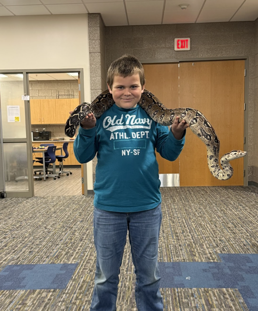 Fourth graders just wrapped up their Unit 1 in science, where they explored animal structures and how animals use these features to gather information from their environment in order to get food and protect themselves. As an extension of their learning, they had the exciting opportunity for Snake Discovery to visit and present to them. Fourth graders participated in their “Snake, Rattle, and Roll” program. The presentation focused on the reptiles and amphibians that call Minnesota and Wisconsin home. Students had the chance to watch a salamander eat, touch shredded skin, and even hold a large snake for a truly hands on experience! 🐍🦎