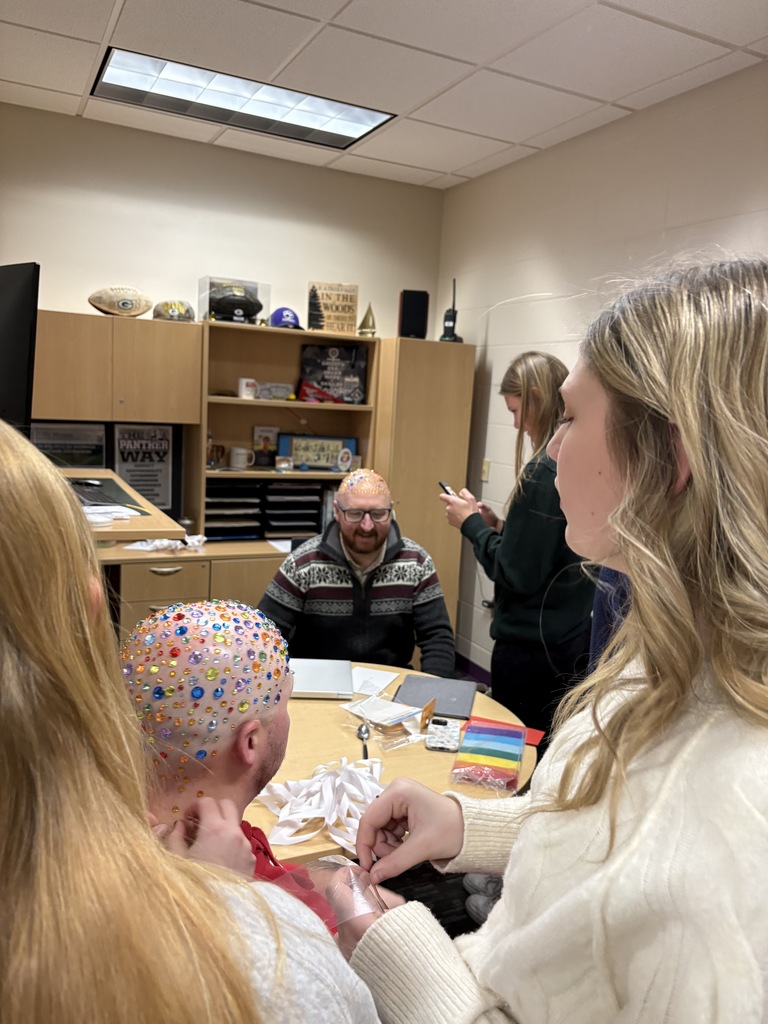 Talk about being good sports! 😄✨  At EMS, we celebrated WinterFest today before kicking off our holiday break, and one group of 8th grade girls had a very creative way to spread some school spirit. They earned the chance to bedazzle Principal Morrison, band director Mr. Morley, and our new PE teacher Mr. Campbell.  Thanks to these three for being such great sports and helping make WinterFest a memorable way to wrap up the semester! 💜❄️
