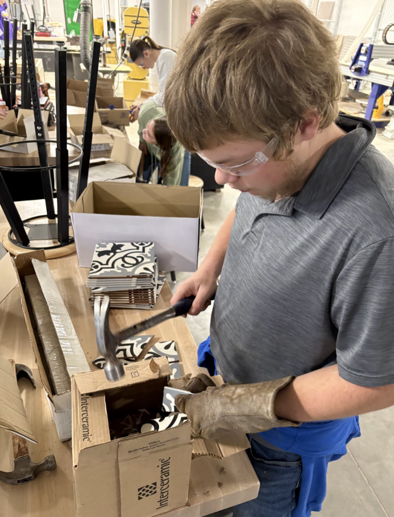 📐🧱 Math You Can Actually See! 🧱📐  Ms. Steitz’s and Mrs. Marson’s Math for the Trades class has been busy turning math into something hands-on and beautiful. Thanks to the generosity of H&F Flooring and Home Design, students received donated tile to create their own mosaic-tiled tables.  While designing their projects, students practiced real-world skills like mixing materials in proper ratios by volume, estimating area, and applying math concepts in a practical setting. It’s one thing to solve a problem on paper and another to bring it to life with your own hands.  We are so grateful to our community partners for supporting our students and helping make learning meaningful. Panther Pride in action! 💜🖤 #PantherPride