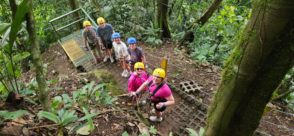 What an incredible spring break adventure for our Ellsworth High School International Club! ✈️🌎  A group of 33 EHS students and chaperones traveled to Costa Rica and Panama, experiencing the culture, food, and natural beauty of both countries while making memories that will last a lifetime.  Along the way, students had the chance to: 🌴 Zip line through the rainforest 🤿 Snorkel in the Pacific Ocean 🛶 Kayak near La Fortuna, Costa Rica 💦 Climb the 500+ steps to see the beautiful La Fortuna waterfall  In Panama, the adventure continued with: 🏄 Surfing lessons 🚤 Boating on Lake Gatun 🚢 Watching the Panama Canal in action  Students also enjoyed incredible local food and learned about the region’s culture and businesses, including a visit to a cocoa bean plantation.  It was an unforgettable experience filled with learning, exploration, and plenty of fun. Thank you to everyone who helped make this trip possible! 💜🖤 #PantherPride