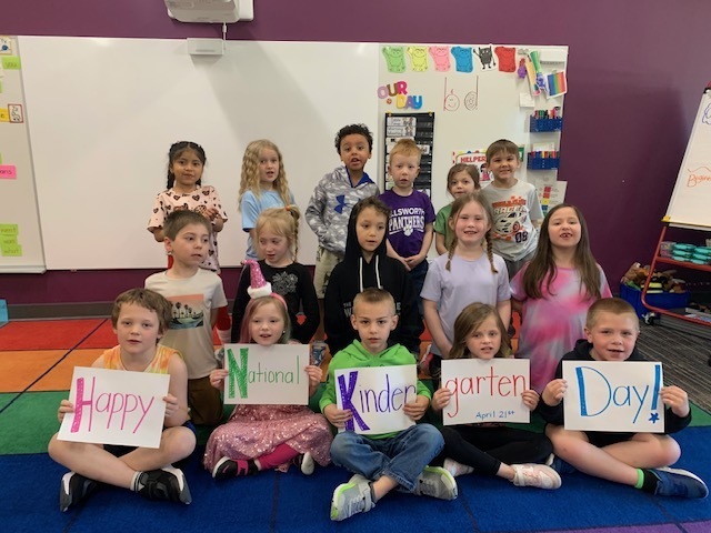 picture of kindergarten students holding up signs that say happy national kindergarten day