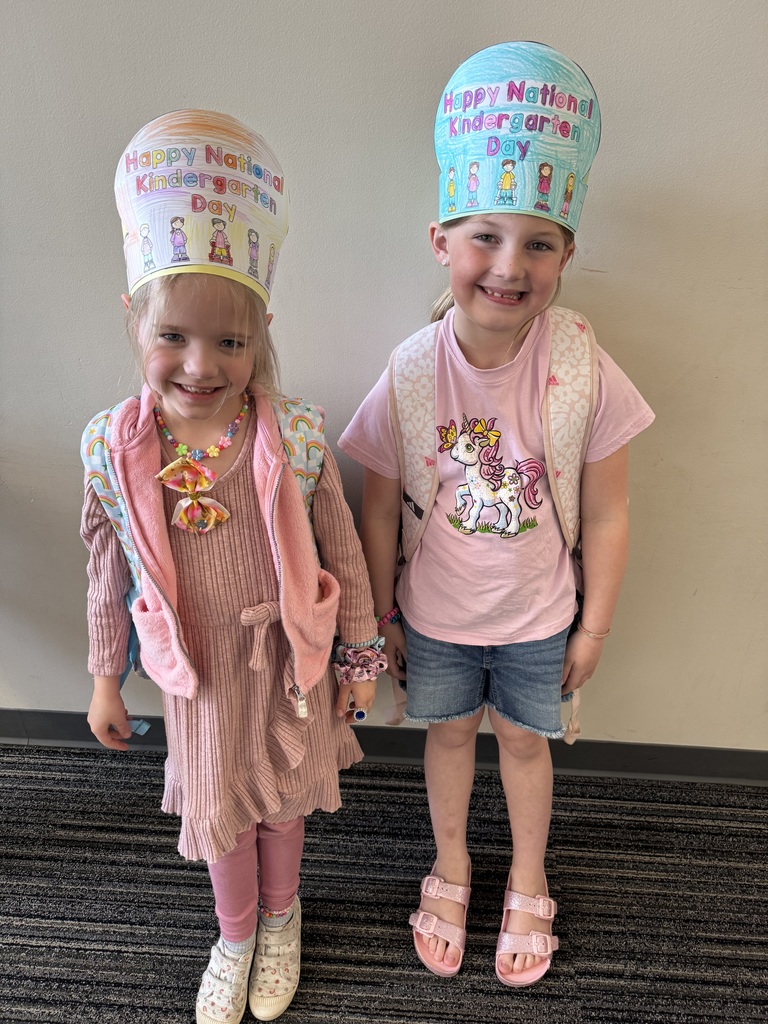 2 students with hats that say national kindergarten day