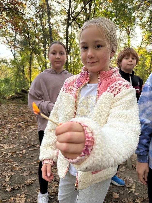🔥🌲 Learning Outside the Classroom! 🌲🔥  Our 5th graders recently enjoyed an awesome outdoor adventure with Red Wing ELC!  Students had several activities to choose from, including outdoor cookery, fishing at the Alma Float, rock climbing, outdoor photography, and canoeing. 🎣🧗📸🛶  During outdoor cookery, students learned how to safely gather wood and start a fire with supervision. Then came the tasty part! They cooked over an open campfire, making bannock (pancakes with cornmeal), ham and cheese pudgie pies, pizza quesadillas, and banana boats. 🔥🍌  What a great opportunity for our students to get outside, try something new, learn some hands-on skills, and make memories with their classmates!  A big thank you to Red Wing ELC for providing such a fun and memorable experience for our 5th graders! 💜