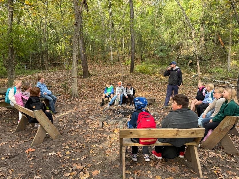 🔥🌲 Learning Outside the Classroom! 🌲🔥  Our 5th graders recently enjoyed an awesome outdoor adventure with Red Wing ELC!  Students had several activities to choose from, including outdoor cookery, fishing at the Alma Float, rock climbing, outdoor photography, and canoeing. 🎣🧗📸🛶  During outdoor cookery, students learned how to safely gather wood and start a fire with supervision. Then came the tasty part! They cooked over an open campfire, making bannock (pancakes with cornmeal), ham and cheese pudgie pies, pizza quesadillas, and banana boats. 🔥🍌  What a great opportunity for our students to get outside, try something new, learn some hands-on skills, and make memories with their classmates!  A big thank you to Red Wing ELC for providing such a fun and memorable experience for our 5th graders! 💜