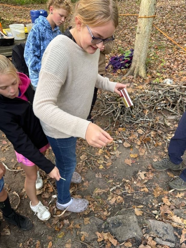 🔥🌲 Learning Outside the Classroom! 🌲🔥  Our 5th graders recently enjoyed an awesome outdoor adventure with Red Wing ELC!  Students had several activities to choose from, including outdoor cookery, fishing at the Alma Float, rock climbing, outdoor photography, and canoeing. 🎣🧗📸🛶  During outdoor cookery, students learned how to safely gather wood and start a fire with supervision. Then came the tasty part! They cooked over an open campfire, making bannock (pancakes with cornmeal), ham and cheese pudgie pies, pizza quesadillas, and banana boats. 🔥🍌  What a great opportunity for our students to get outside, try something new, learn some hands-on skills, and make memories with their classmates!  A big thank you to Red Wing ELC for providing such a fun and memorable experience for our 5th graders! 💜