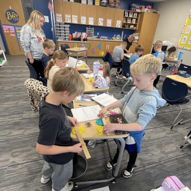 third graders making butterfly fossils