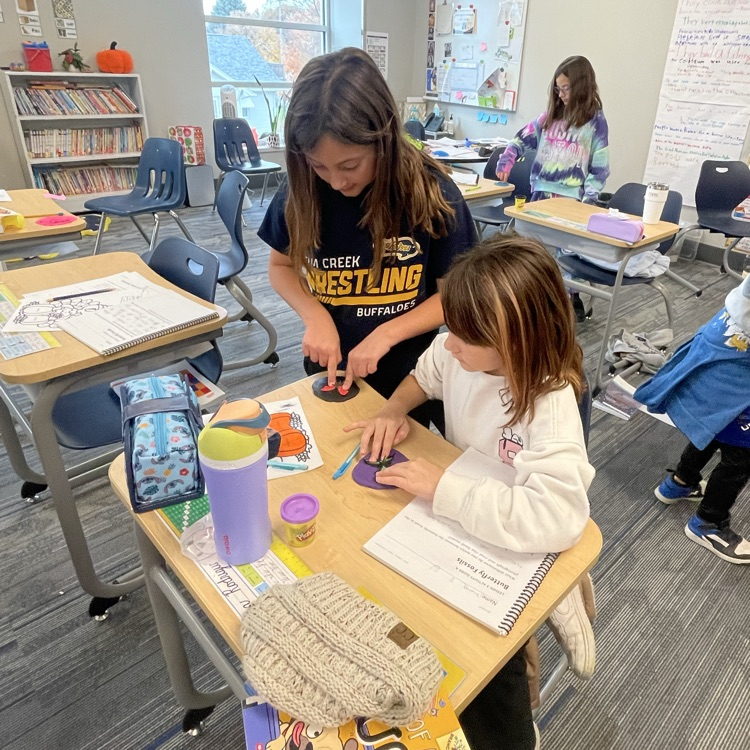 third graders making butterfly fossils