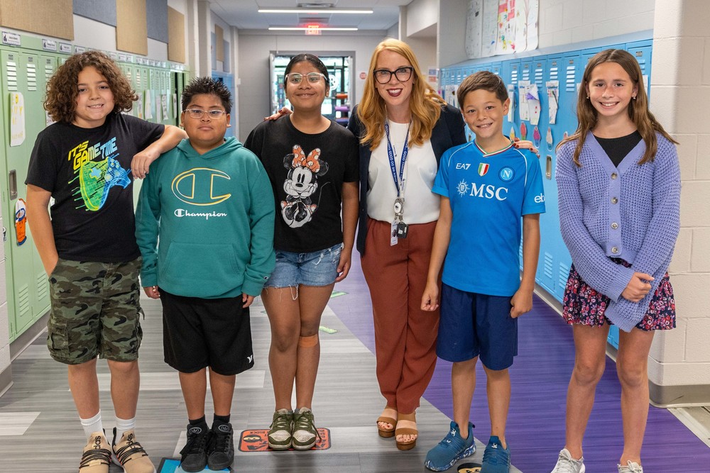 Jill Zapata, the newly approved Principal of Emerson Elementary pictured with students from D205