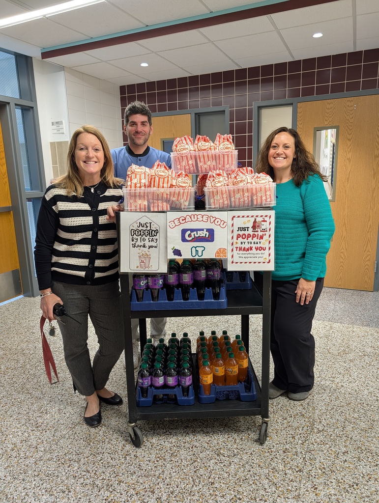 Administrators passing out popcorn and soda for staff appreciation.