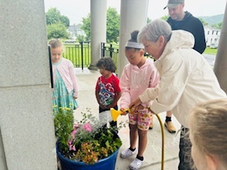Students watering flowers
