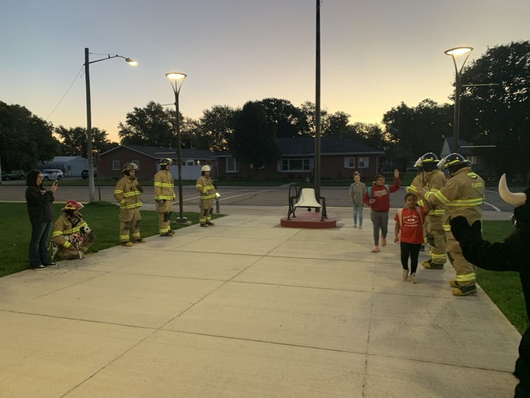 Fireman giving students high fives to start the day