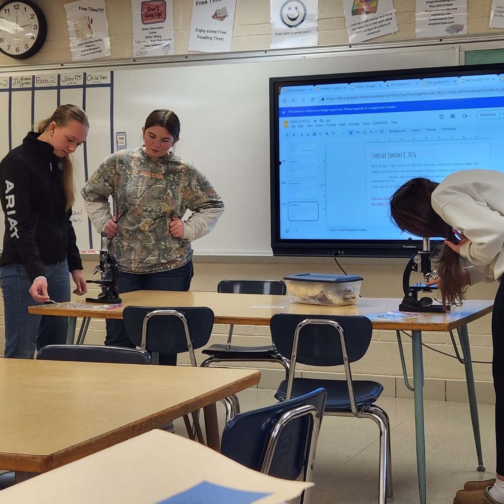 Intro to FCS students exploring fibers that make up fabrics