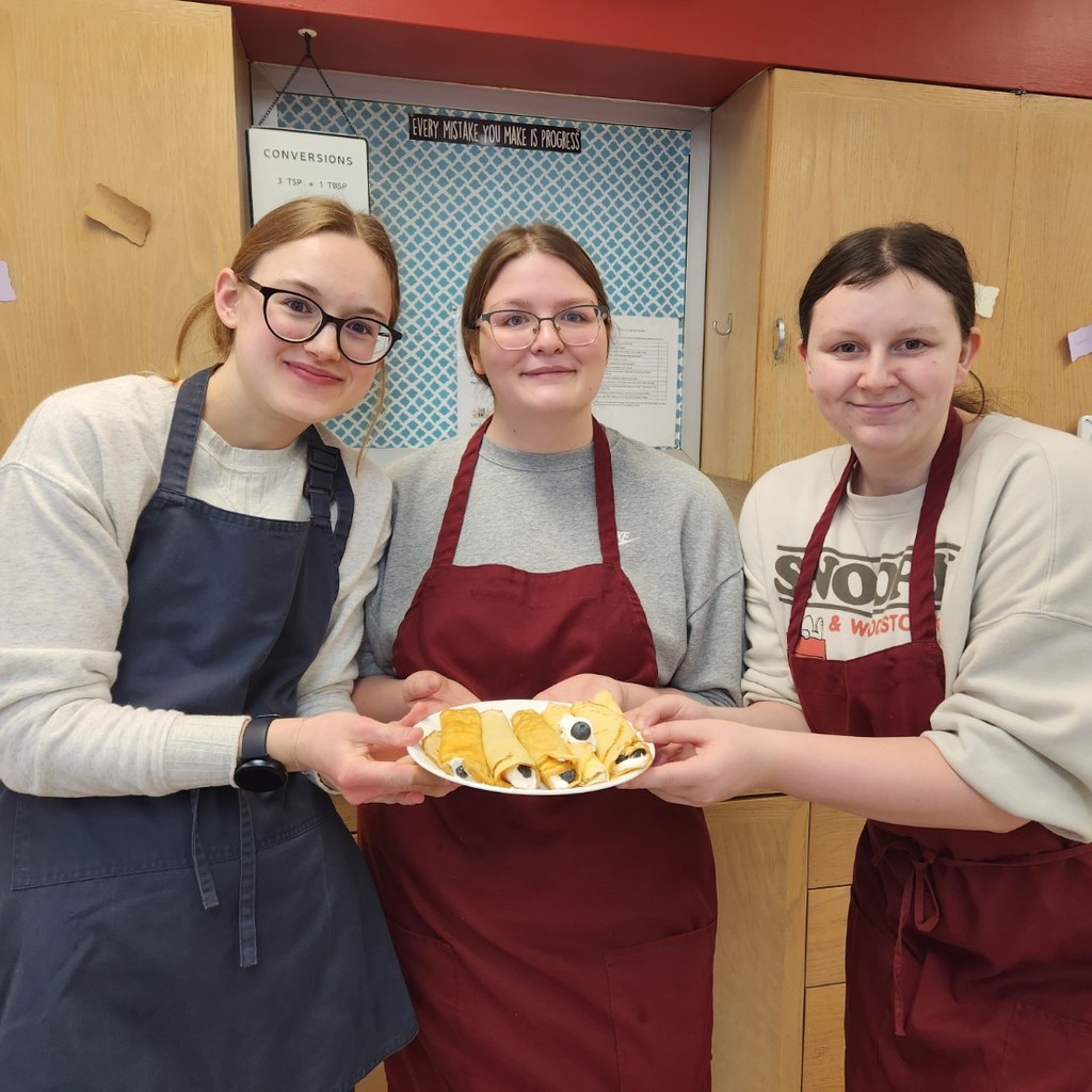 Girls made French crepes filled with cream and blueberries. 