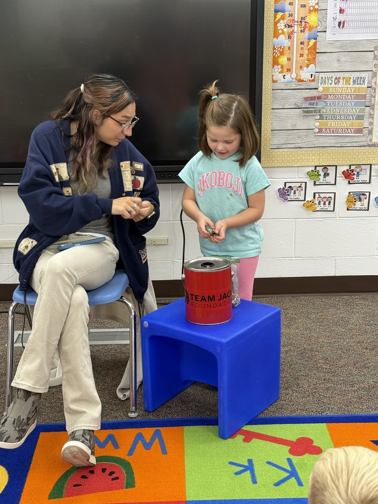 TW putting pennies in the container