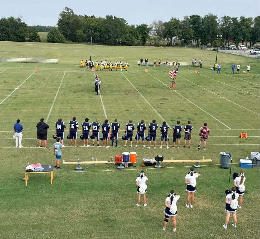 Football team, flag and cheerleaders