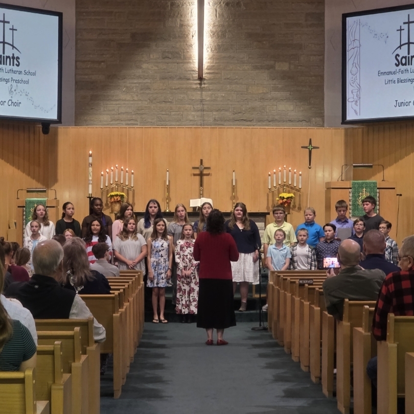 Junior Choir students singing in front of the church sanctuary