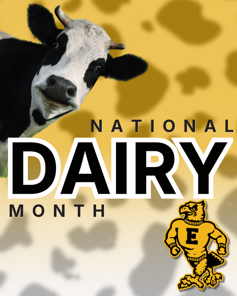 National Dairy Month graphic featuring a black-and-white dairy cow peeking in from the left, bold “Dairy Month” text, and a yellow school mascot on a cow-print background.