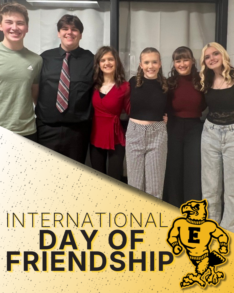 A group of six students standing arm in arm with the text "International Day of Friendship" and the Emmetsburg E-Hawk below.