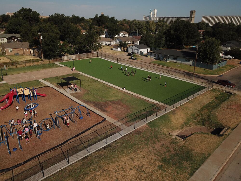 Coolidge turf displayed on the playground with children playing on it at recess