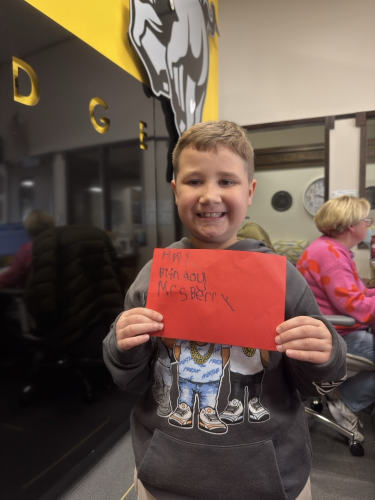 Ezekiel holding a valentine card for a teacher