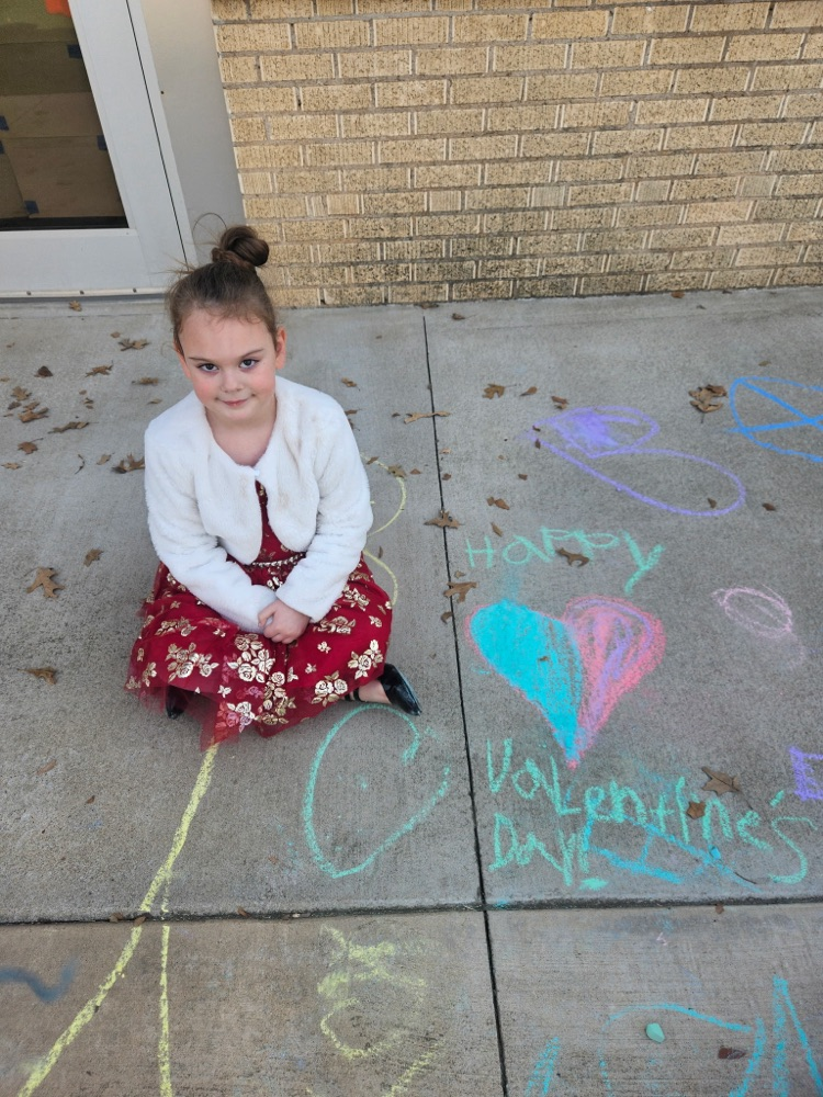addalynn sitting with her chalk art for Valentine's Day