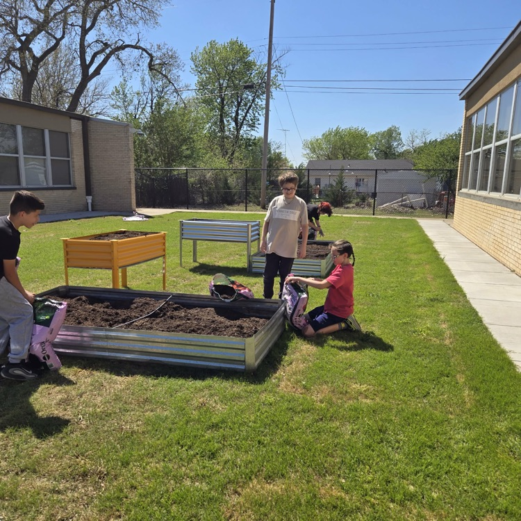 The Monroe Garden Club preps our new garden boxes.💙🦁💛