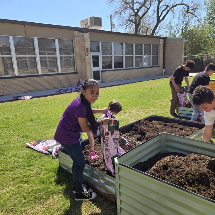 The Monroe Garden Club preps our new garden boxes.💙🦁💛
