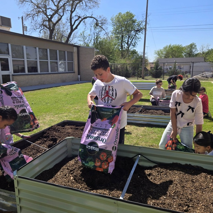 The Monroe Garden Club preps our new garden boxes.💙🦁💛