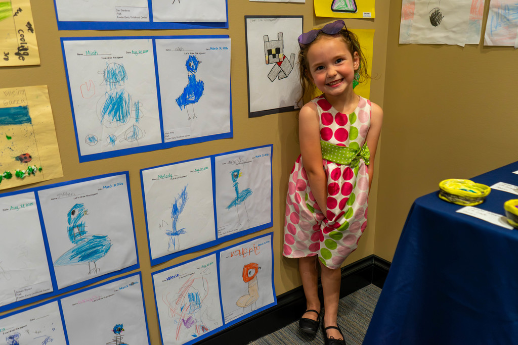 Elementary student standing with her art