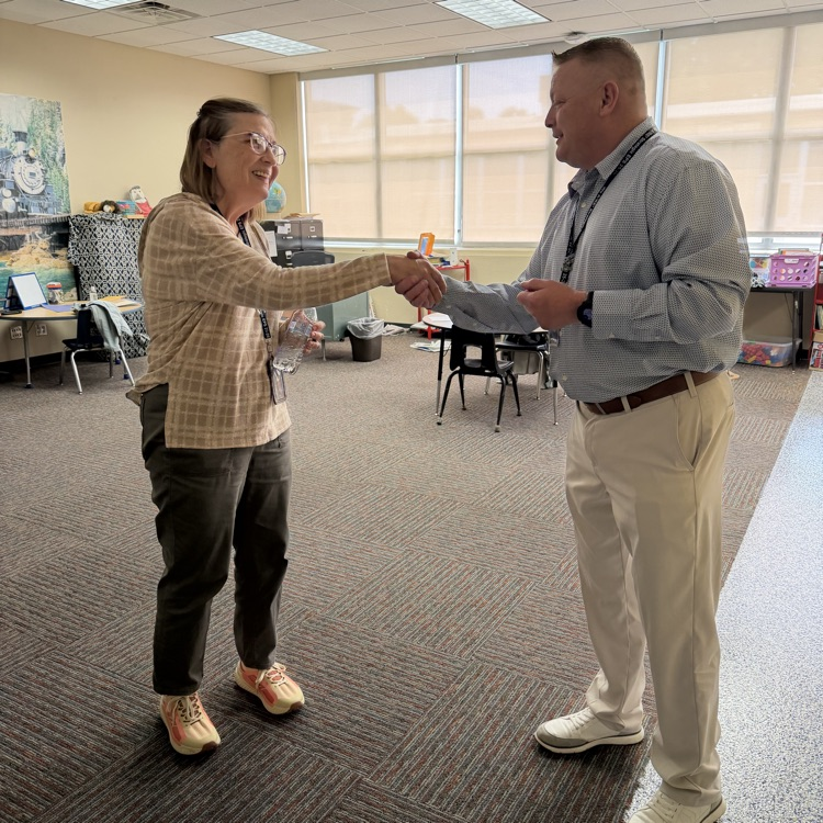 Ms. Smith received her district coin for being Teacher of the Year.💛🦁💙