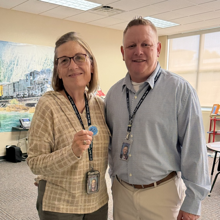 Ms. Smith received her district coin for being Teacher of the Year.💛🦁💙