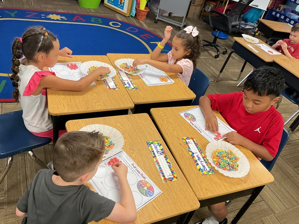 1st grade students sorting & graphing fruit loops by color