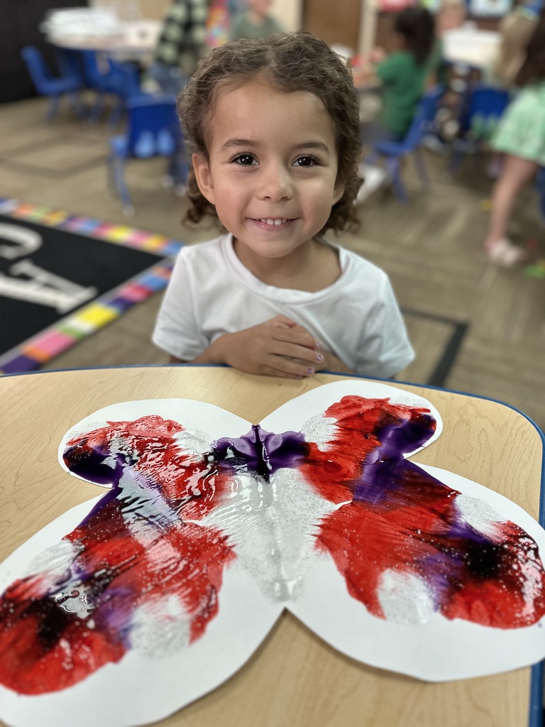 Little girl smiling with her painted butterfly