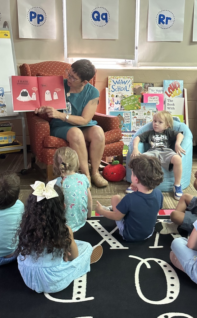 Mrs. Terry reading to Mrs. Silva's Pre-K class