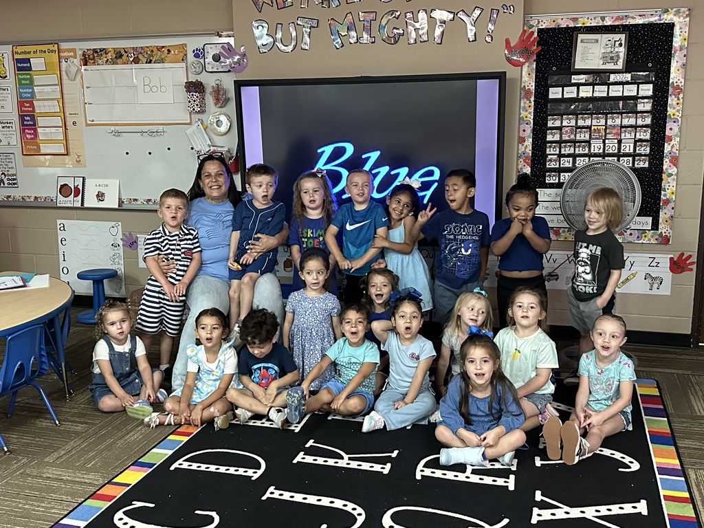 Mrs. Silva's pre-k class posing in their blue outfits for blue day