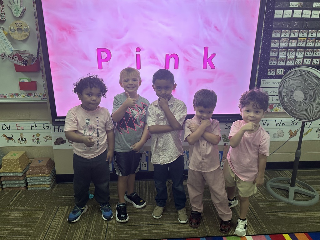A group of boys showing they wear pink also!