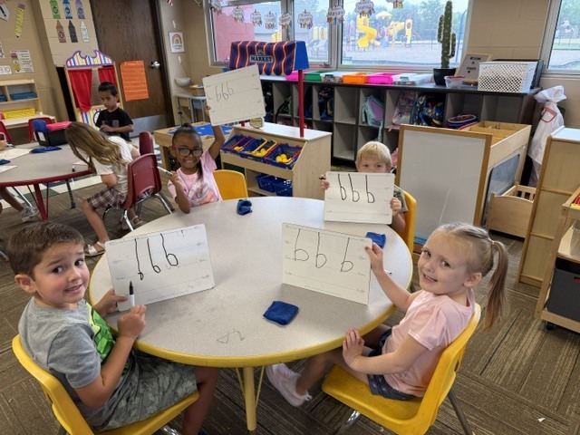 Mrs. Sutherland's class showing their drawings of smart cookies