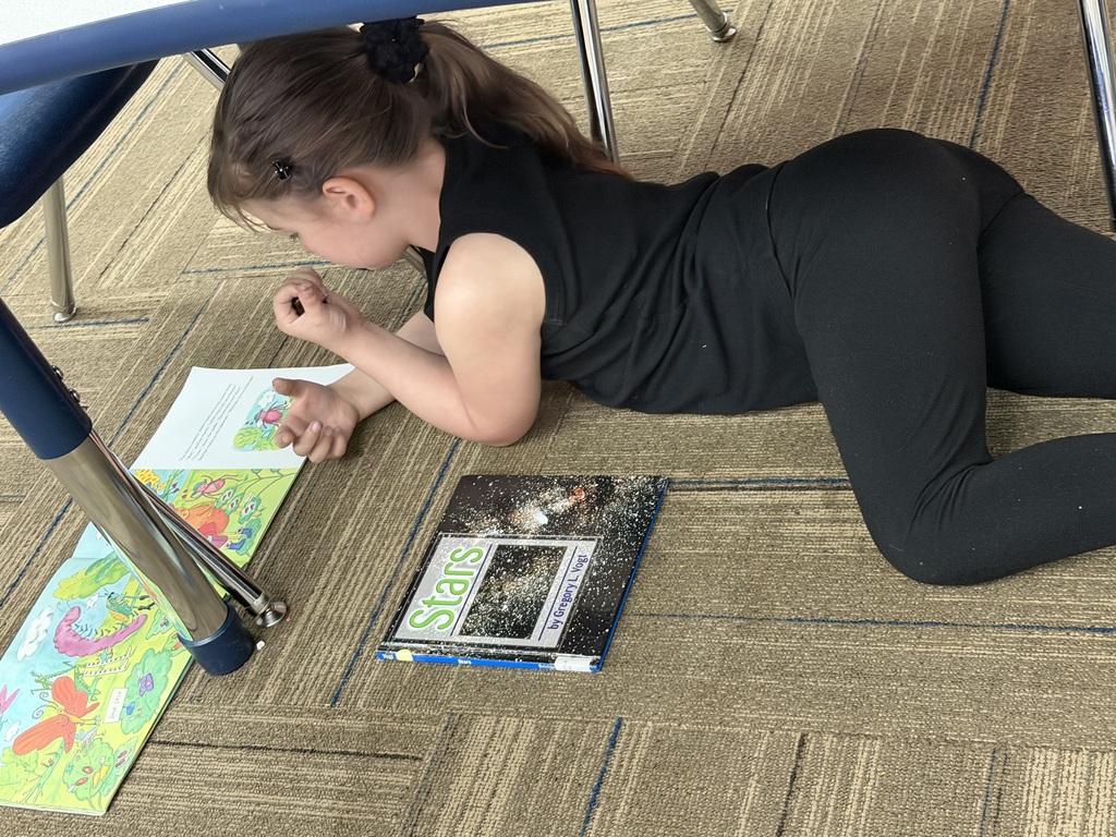 Young girl lying on the floor reading