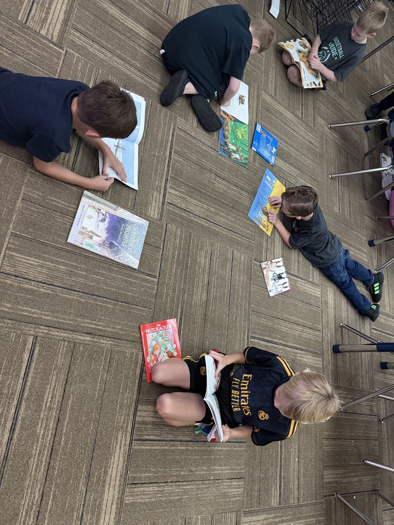 A group of children sitting in a circle reading