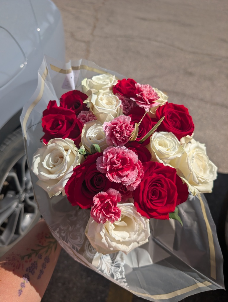 A bouquet of red & white roses with pink carnations