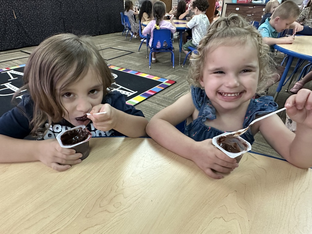 Two girls enjoying chocolate pudding