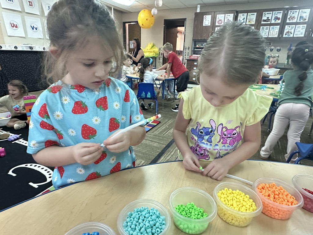 Two girls making bracelets