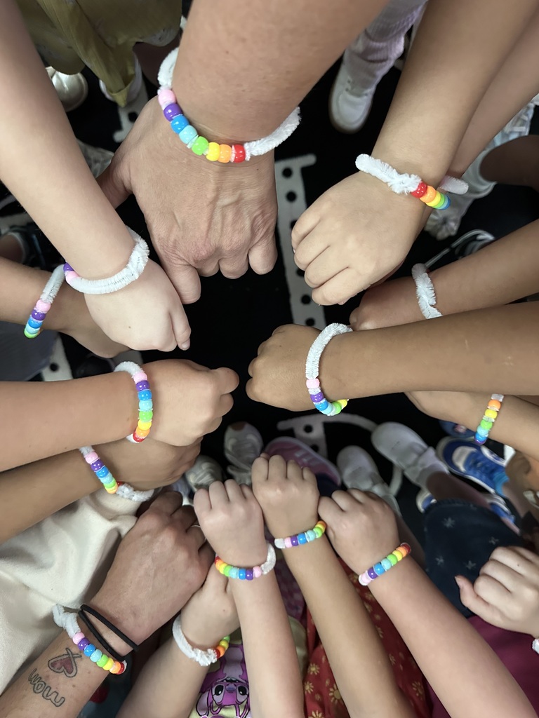 Kids showing their bracelets off together