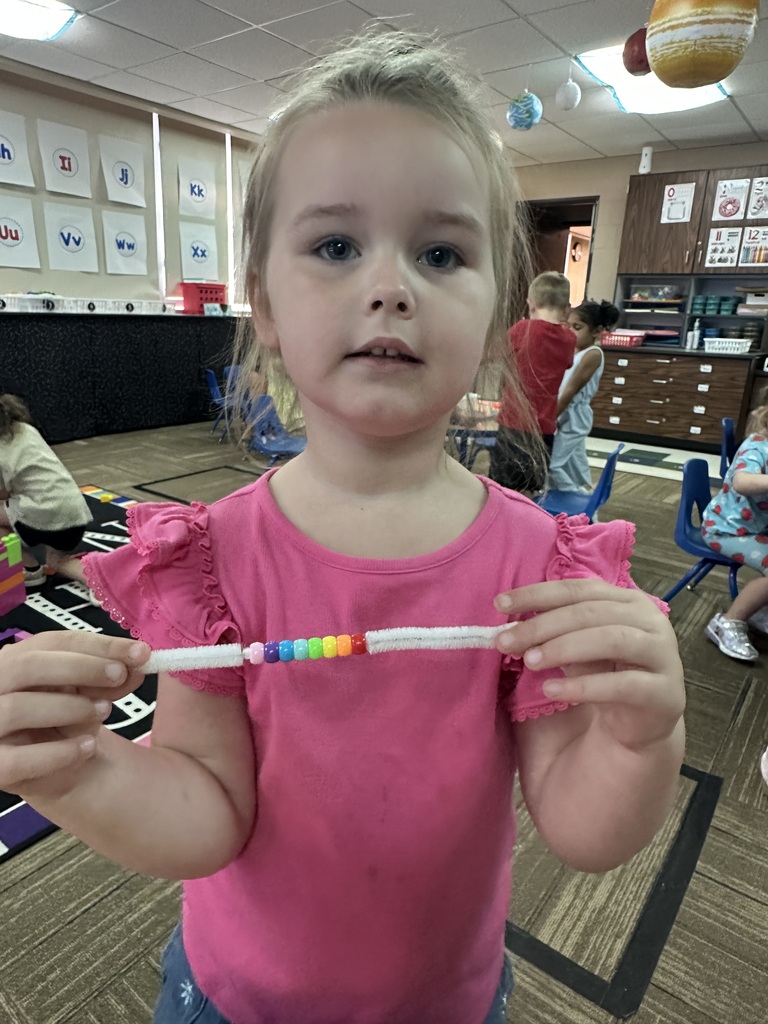 Little girl holding her bracelet up