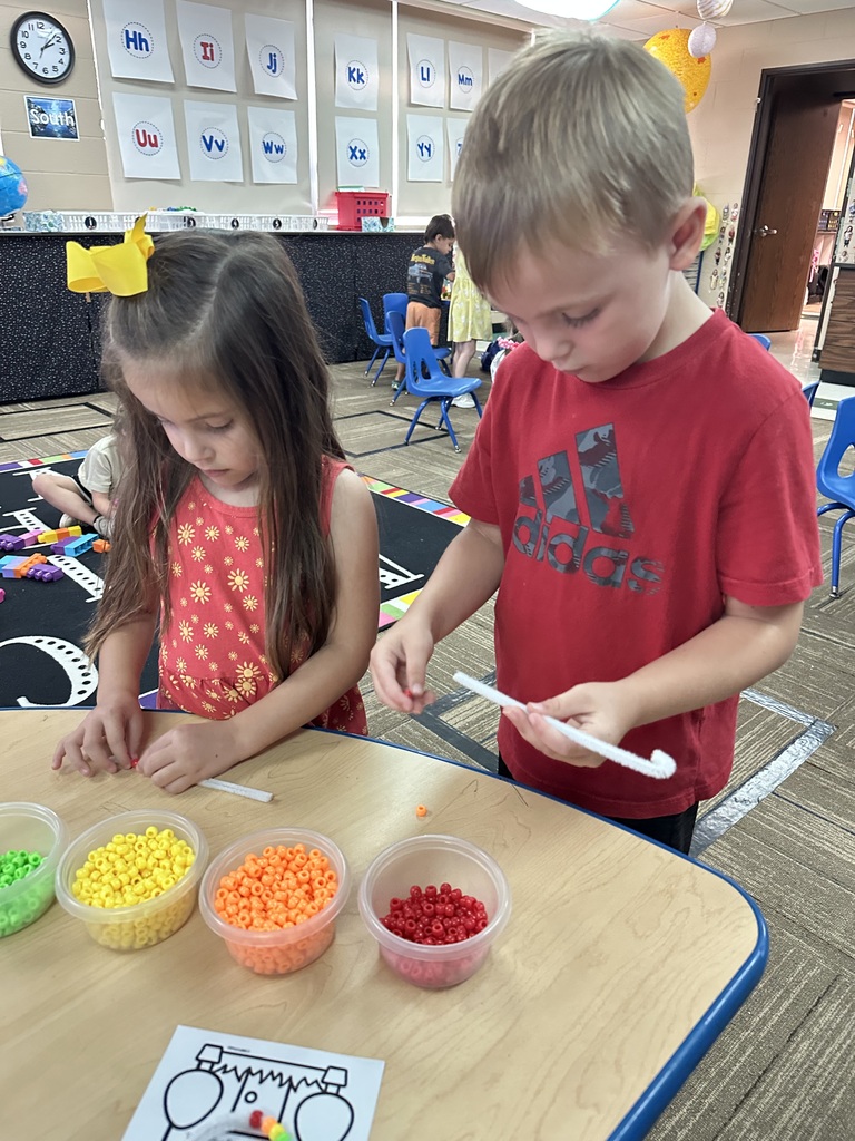 Two kids starting to make their bracelets